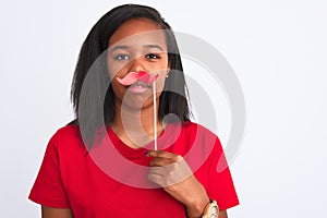 Young african american woman wearing vintage pretend mustache over isolated background with a confident expression on smart face