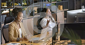 Young African American woman works at her desk in a business office setting