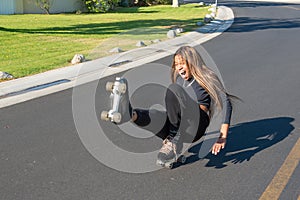 Young African-American women falls roller skating on street