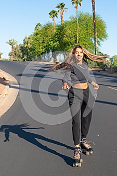 Young African-American women roller skates on street