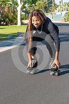 Young African-American women roller skates on street