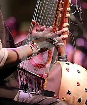 Young african boy plays a stringed instrument