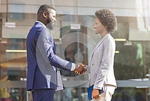 Young african business people shaking hands outdoors