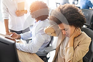 Young african business woman having stress and headache in the office