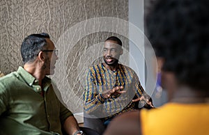 Young African businessman talking with colleagues during a meeting