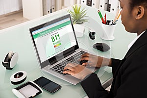 Businesswoman Checking Credit Score On Laptop photo
