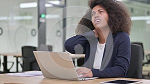 Young African Businesswoman with Laptop having Neck Pain