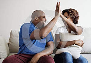 A young African couple success dealing together high five