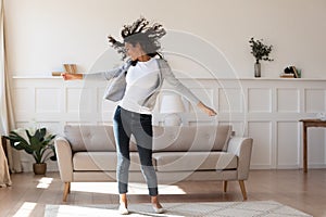 Young african ethnicity multiracial woman dancing indoors.