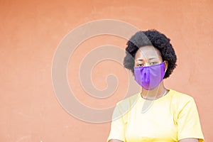 Young African female wearing a face mask doing given our love, hope, and believe