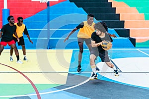 Young African friends playing basketball outdoor