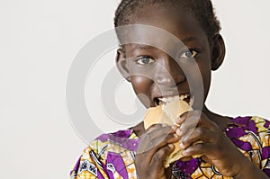 Young African girl eating some bread - isolated on white