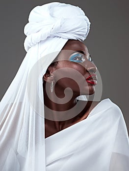 Young, African and girl in traditional fashion, beauty and clothing with makeup, cosmetic and head scarf in studio