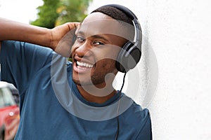 Young african guy listening to music on headphones