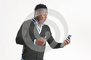 Young african guy looking at cell phone