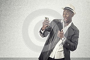 Young african guy looking at cell phone