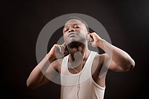 Young African male listening to music with closed eyes