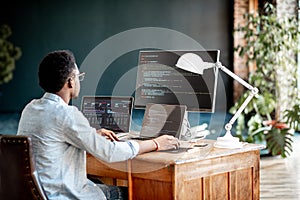 Programmer working with program code photo