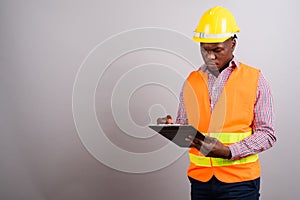 Young African man construction worker against white background