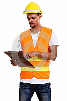 Young African man construction worker reading on clipboard