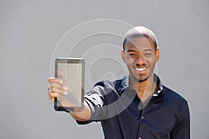 Young african man holding digital tablet