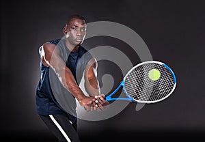 Young african man playing tennis