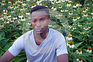 Young african man portrait flower background rural lifestyle garden