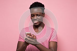 Young african man reading sms on the phone