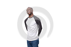 young african man with short haircut smiling cutely on studio background with copy space