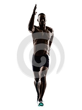 Young african muscular build man jumping running silhouette