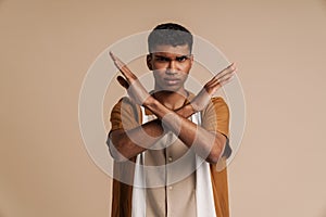 Young african serious man showing rejection gesture with crossed arms