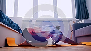 Young african woman exercising on the yoga mat in her bedroom