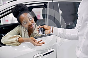 Young african woman fulfilled her dream, bought a car