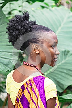 Young african woman looks at camera half-turned