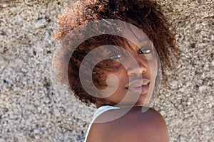 Young african woman posing sensually outdoors