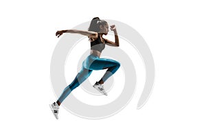 Young african woman running or jogging isolated on white studio background.