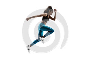 Young african woman running or jogging isolated on white studio background.