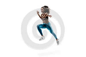 Young african woman running or jogging isolated on white studio background.