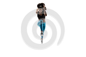 Young african woman running or jogging isolated on white studio background.