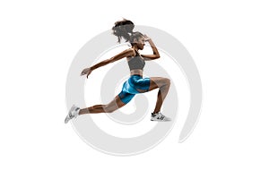 Young african woman running or jogging isolated on white studio background.