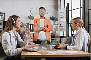 Young african woman standing at boardroom standing at boardroom with crossed arms