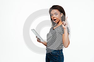 Young african woman using tablet computer and have an idea.