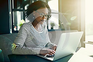 Young African woman working online with a laptop