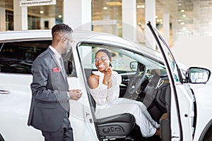 Young woman surprised by new car, gift for my beautiful wife photo