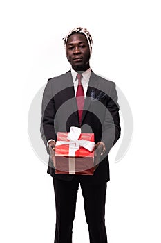 Young afro american businessman holding gift box in hands on isolated white background