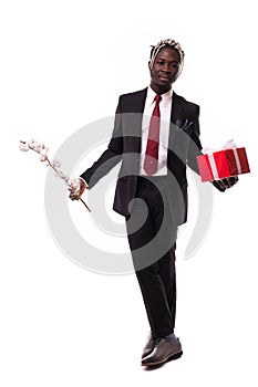 Young afro american businessman holding gift box in hands on isolated white background