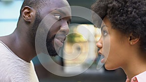 Young afro-american couple arguing outdoor, misunderstanding, jealous spouse