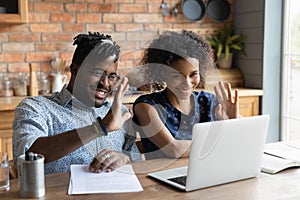 Young afro american couple contact lawyer by videocall wave hands