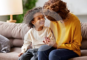 Young afro american family mother and son enjoying time together at home