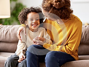 Young afro american family mother and son enjoying time together at home